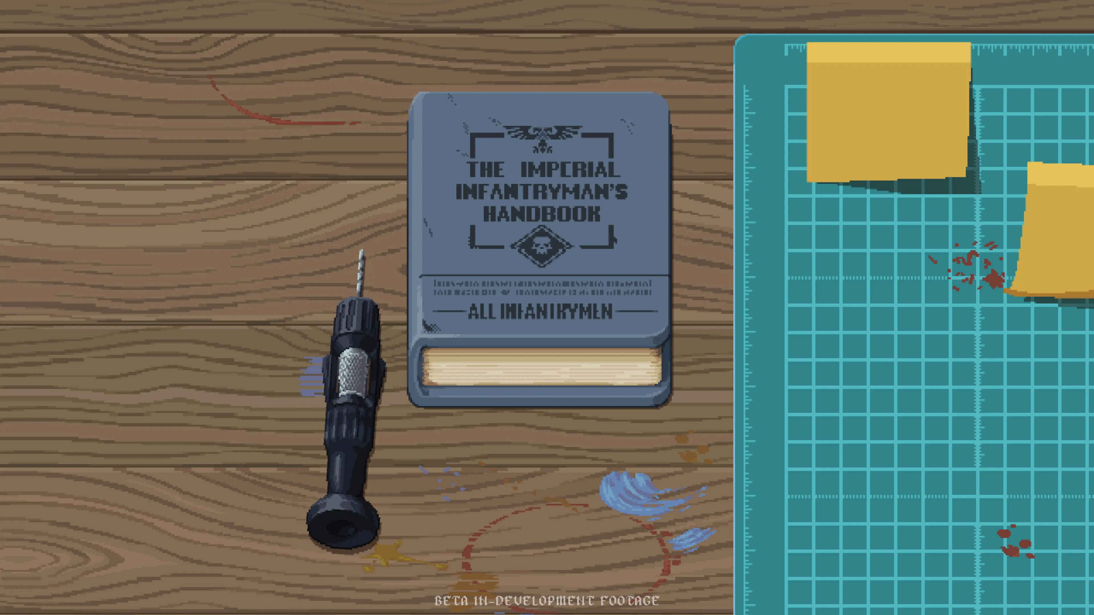 Imperial Infantryman Handbook lying on a wooden hobby workbench beside a cutting mat